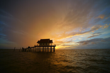 the sun rises from the sea in the morning