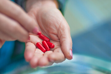 hand holds  effective red antiviral or antibacterial pills