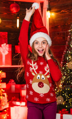 Christmas mood concept. Fancy style. Happy winter holidays. Christmas coming. Favorite sweater. Small girl. Little girl child in santa red hat. New year party. Santa claus kid. Christmas shopping