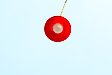 The lamp with red rounded plastic bowl top of the row