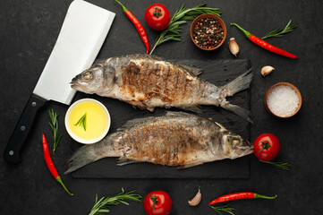 grilled sea bass fish with spices on a stone background