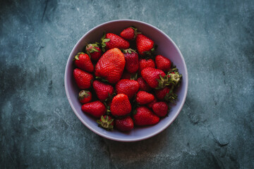 fresh strawberries lies on a gray background