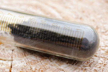 Black iron oxide in a measuring tube, the substance is used as an inorganic dye.