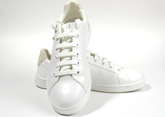 White sneakers on white background including edging