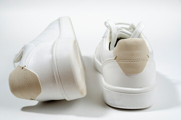 White sneakers on white background including edging