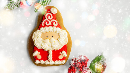 Gingerbread man Christmas cookies with hat beard and mustache of Santa Claus. Santa Claus with Christmas tree branches, top view. close up.