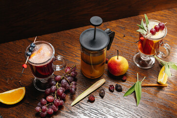 Various autumn or winter seasonal alcohol hot cocktails. Blueberry mulled wine, tea with pear and...
