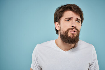 Fototapeta premium Bearded man emotions white t-shirt lifestyle gestures with hands blue backgrounds