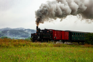 Fototapeta na wymiar Old steam machine in highland landscape.