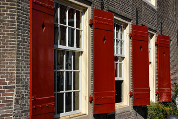 Old windows and shutters of the old church on the Oudezijds Voorburgwal, Amsterdam, the Netherlands.