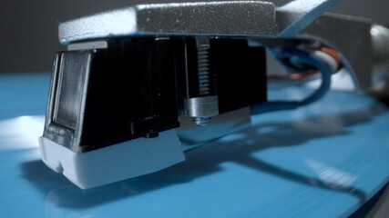 Fototapeta na wymiar Stylus on record player with blue vinyl