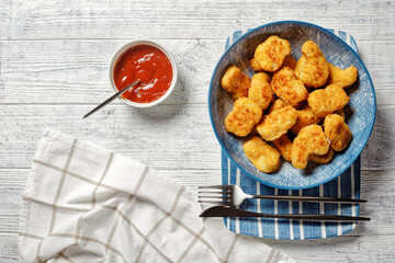 A portion of chicken nuggets with ketchup
