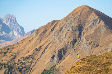 COPY SPACE: Spectacular view of woman during her descent along a grassy mountain