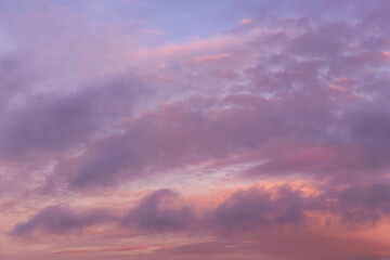 Dramatic soft sunrise, sunset pink violet blue sky with clouds background texture	