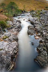 long exposure shot of the waterfalls in glen etive near loch etive and the entrance to glencoe and rannoch moor in the argyll region of the highlands of scotland during autumn