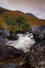 long exposure shot of the waterfalls in glen etive near loch etive and the entrance to glencoe and rannoch moor in the argyll region of the highlands of scotland during autumn