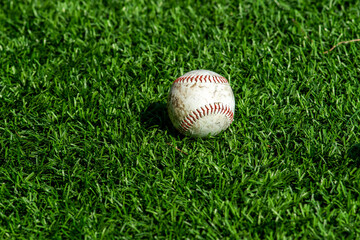 Baseball ball on grass outdoors