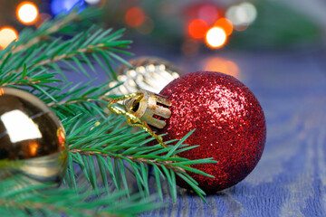 Christmas theme. Red and gold christmas balls. Blure background. Christmas background. Pine branch