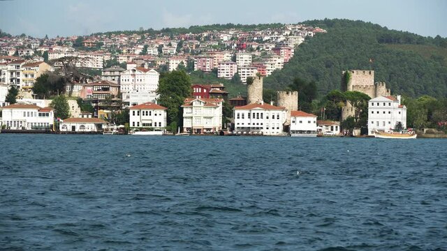 Beuatiful buildings (aka yali) and Anadolu Hisari (Castle) at the bank of Bosphorus, Istanbul, Turkey