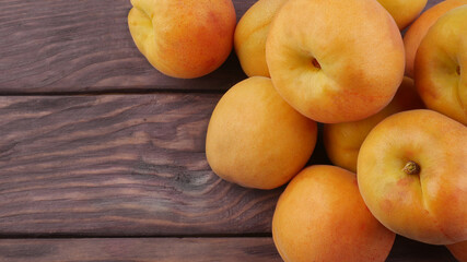 Large ripe fruit of apricot on a wooden table close-up with space for text. Rural market concept.