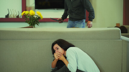 The girl hides in horror at home from a maniac with a knife.