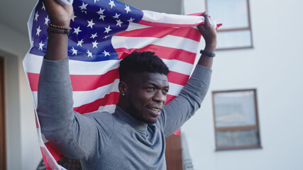 Black man african-american with USA flag on the balcony. High quality photo