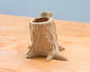 Shot of a 3d printed little bowl planter on a wooden surface