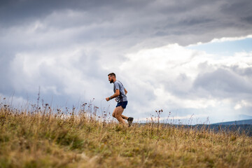 handsome trail runner running in nature