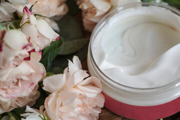 face cream, white, against flowers