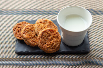 Glass of milk and cookies on the table 