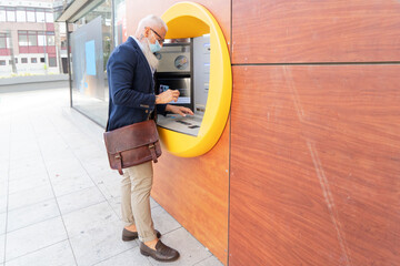 Senior man with ATM