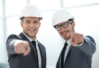 two builders are looking into the camera. concept of construction