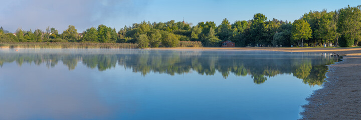 Fototapeta na wymiar Clairvaux-Les-Lacs, France - 09 02 2020: Fog and reflections on the big lake - La Raillette