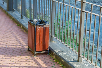 Small street litter bin in a public city park