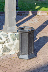 Fototapeta premium Small street litter bin in a public city park
