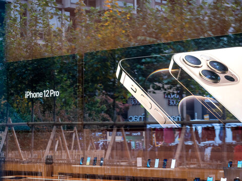 Paris, France - Oct 23, 2020: Reflected ccity in the advertising of the new iPhone 12 and iPhone 12 Pro on display during launch day in Apple Store. Latest 5G smartphones go on sale worldwide.