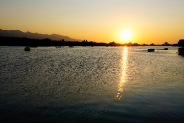 Fototapeta premium boats in the lagoon at sunset
