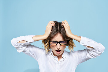 Business woman in a light shirt on a blue background gestures with her hands emotions model work