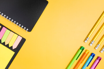 Office supplies on a yellow background. Flat lay. Education and creativity.