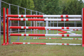 Obraz na płótnie Canvas Obstacles poles barriers for jumping horses as a background