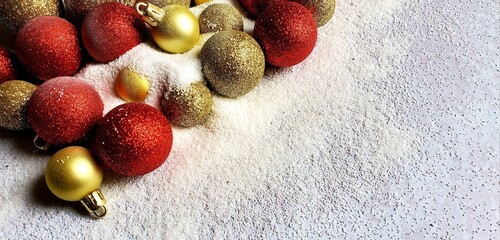 A group of different colored Christmas balls in snow