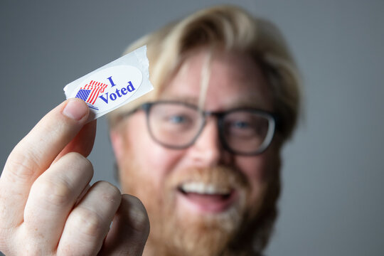 Man Holding I Voted Sticker