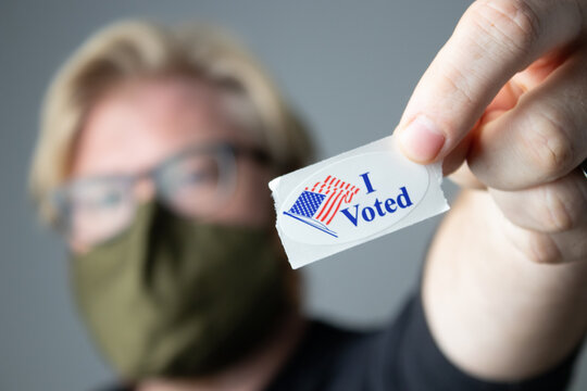 Man Holding I Voted Sticker