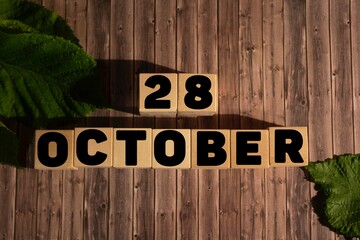 October 28.October 28 on wooden cubes on a wooden background.Autumn.Calendar for October.
