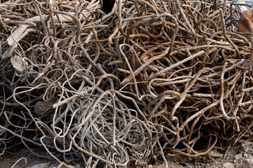 A Heap of construction scrap debris Armature iron round rods pieces of broken concrete curved metal rods