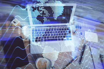 Double exposure of financial chart drawing over table background with computer. Concept of research and analysis. Top view.