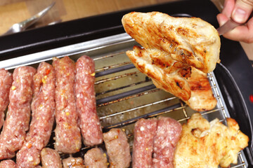 Chicken gilled meat and kebab on a electric  grill.
