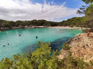 Playa Cala Turqueta famous paradise beach with turquoise water and pine forests on south coast of Menorca Island, Balearic Islands, Spain
