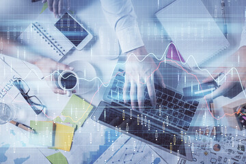 Multi exposure of man's hands typing over computer keyboard and forex graph hologram drawing. Top view. Financial markets concept.