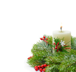 Christmas composition with candle and festive decor, berries and cones. Green garland and tinsel. Isolated.